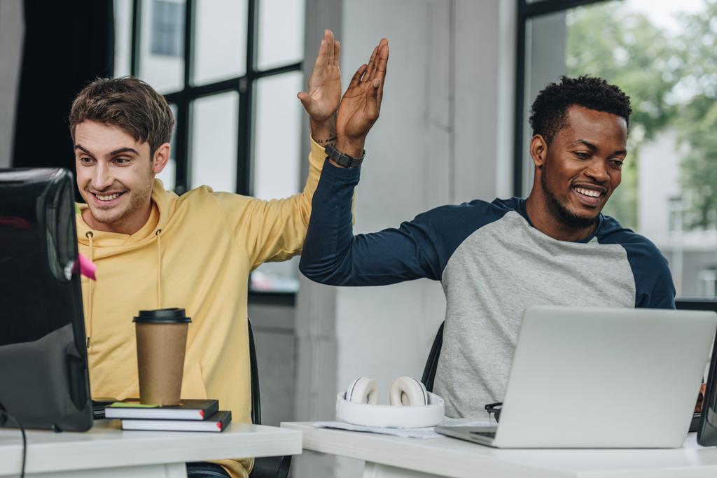stock-photo-happy-multicultural-programmers-giving-high-five-while-working-office-together.jpeg